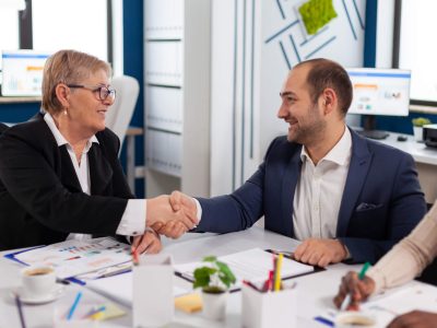 consultant-greeting-international-client-with-handshake-after-partnership.jpg